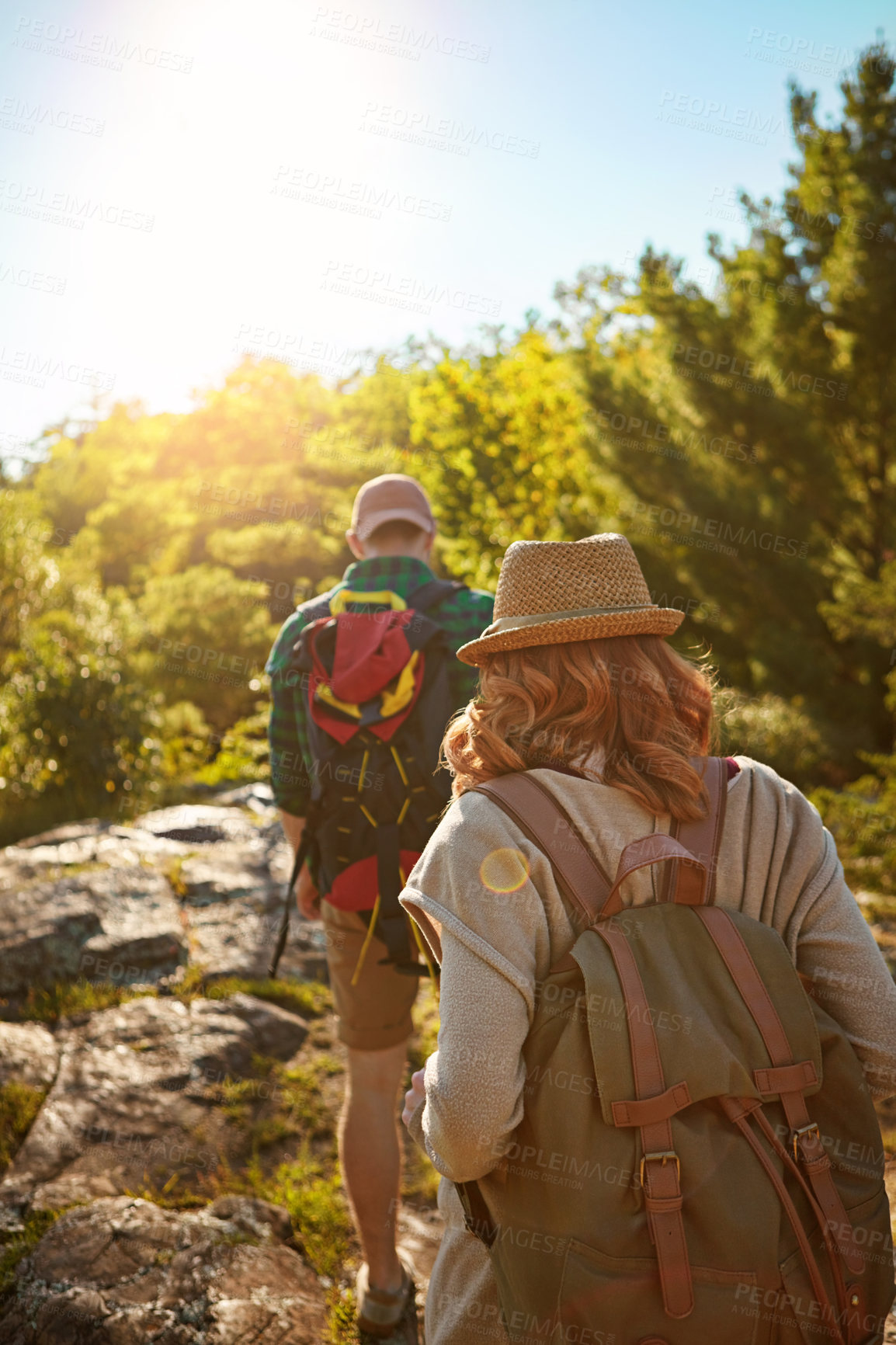 Buy stock photo Nature, hiking and couple with sunshine, walking and adventure holiday in mountain from back. Trekking, man and woman on travel vacation together in park with trees, bush and outdoor climbing date 