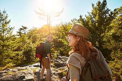 Buy stock photo Mountain, hiking and happy couple with sun, walking and adventure holiday in nature from back. Trekking, man and woman on travel vacation together in park with trees, blue sky and outdoor climbing