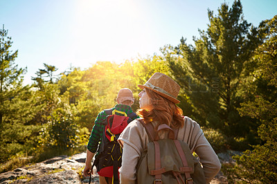 Buy stock photo Mountain, hiking and couple with sunshine, walking and adventure holiday in nature from back. Trekking, man and woman on travel vacation together in park with trees, bush and outdoor climbing date 