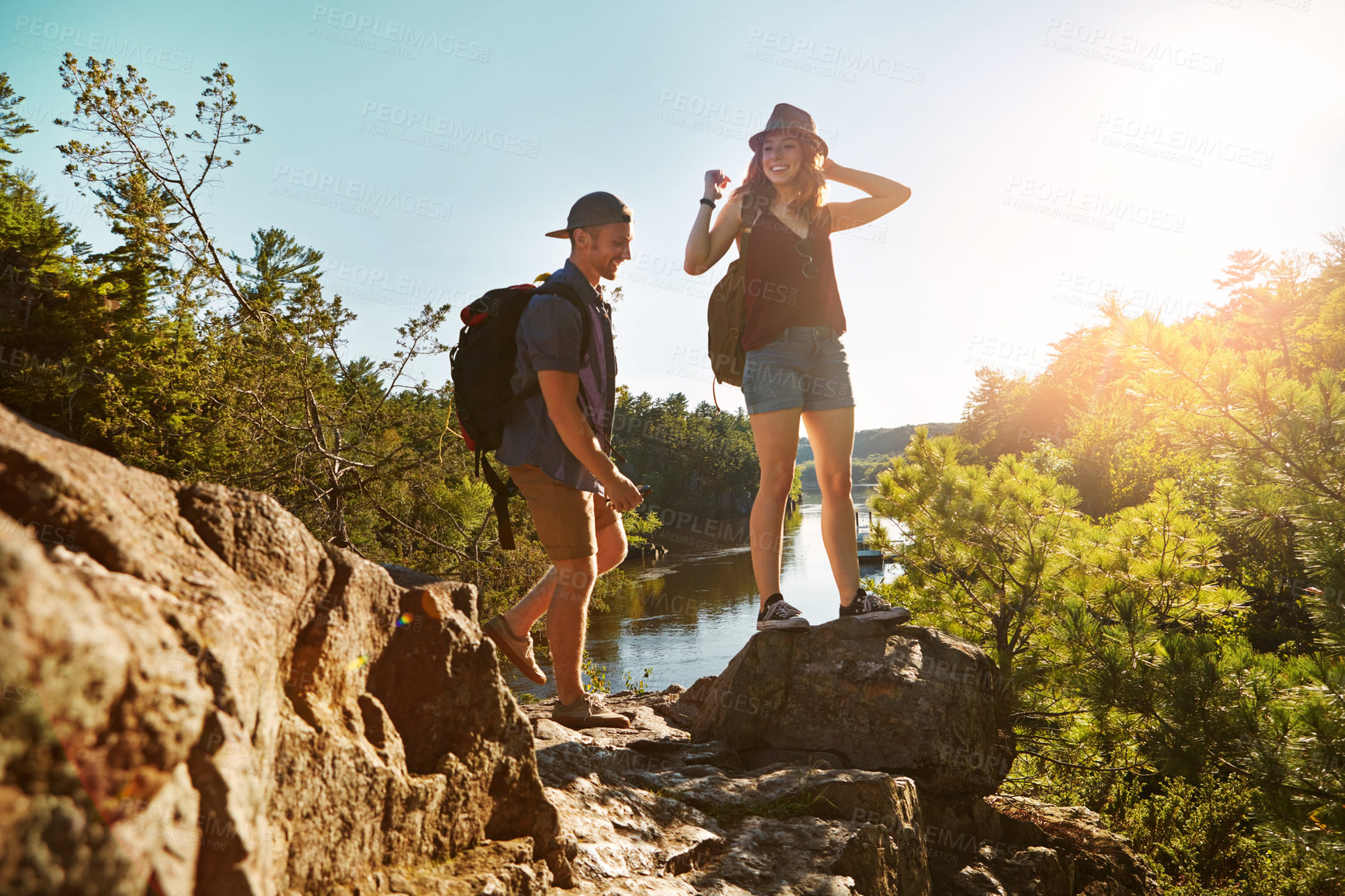 Buy stock photo Climbing, hiking and couple at lake with blue sky on adventure holiday in mountain, trees, and cliff. Trekking, man and woman on happy travel vacation together in nature, rocks or outdoor water park