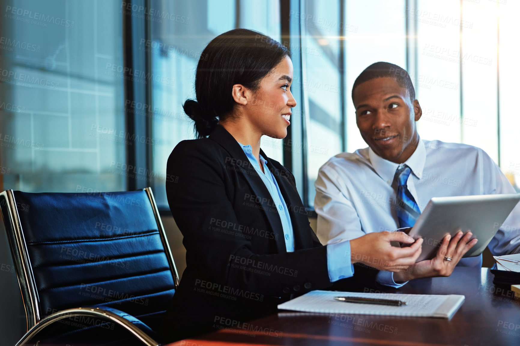 Buy stock photo Cropped shot of two young businesspeople meeting in the boardroom