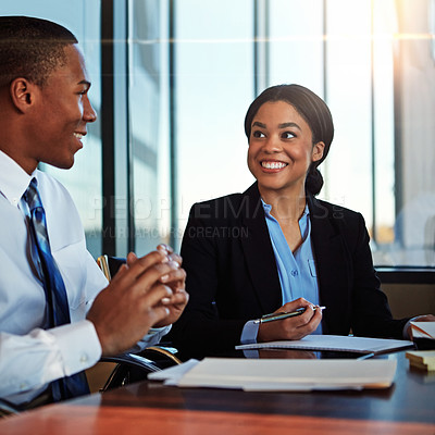 Buy stock photo Cropped shot of two young businesspeople meeting in the boardroom