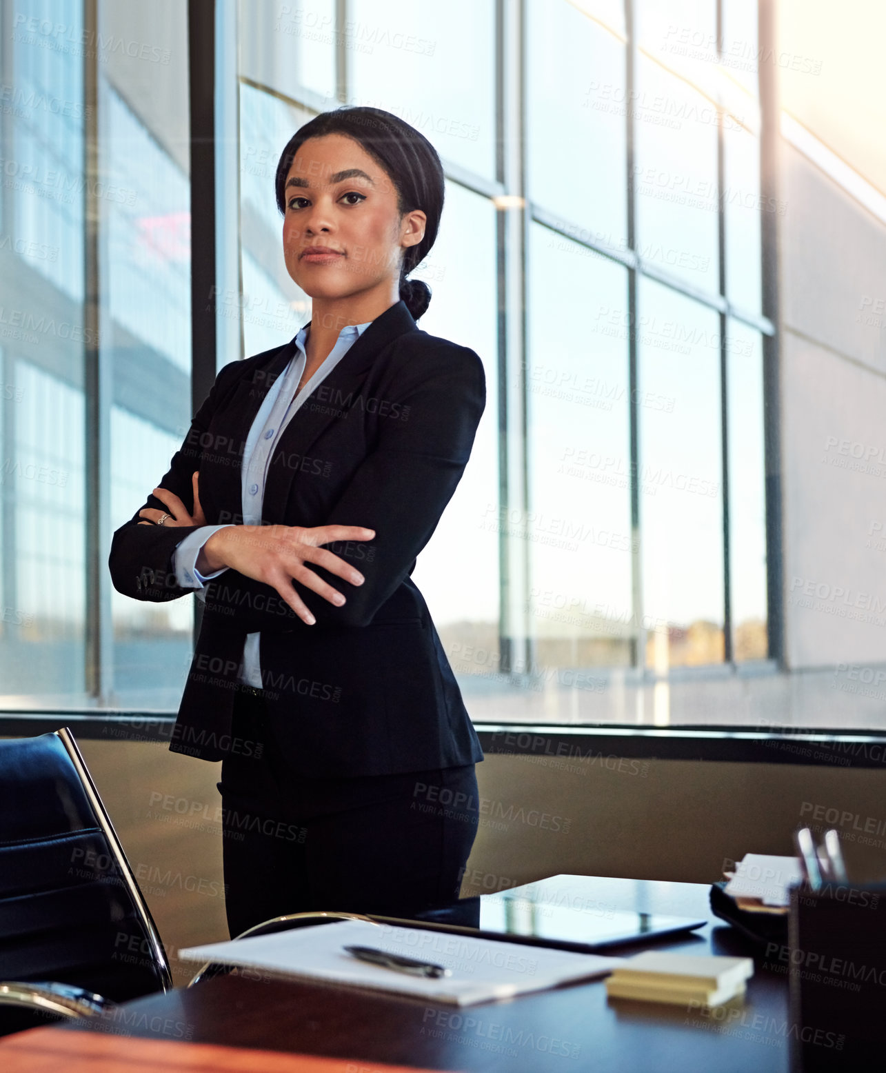 Buy stock photo Portrait of a young female lawyer standing by her desk in the office