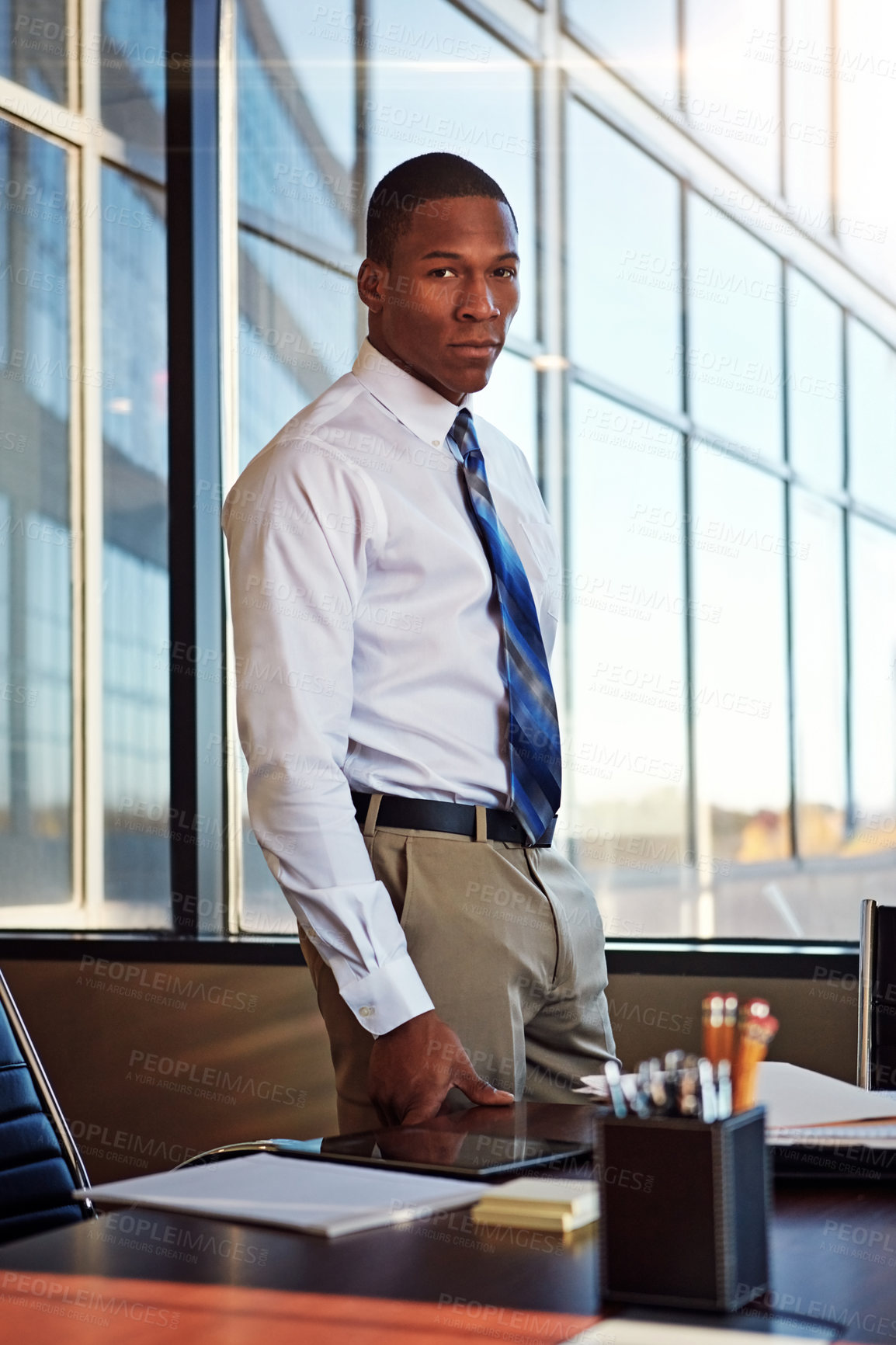 Buy stock photo Portrait of a young male lawyer standing by his desk in the office