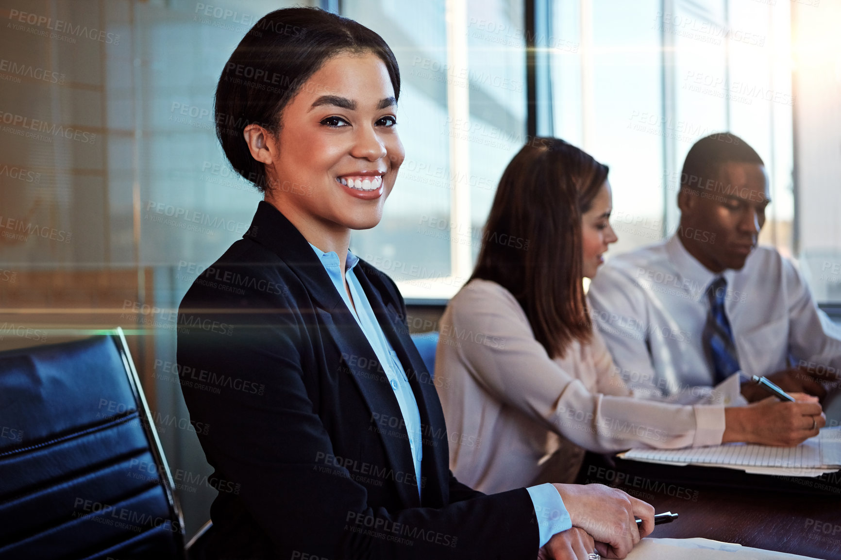 Buy stock photo Cropped portrait of a young businesswoman sitting in a meeting with her boardroom