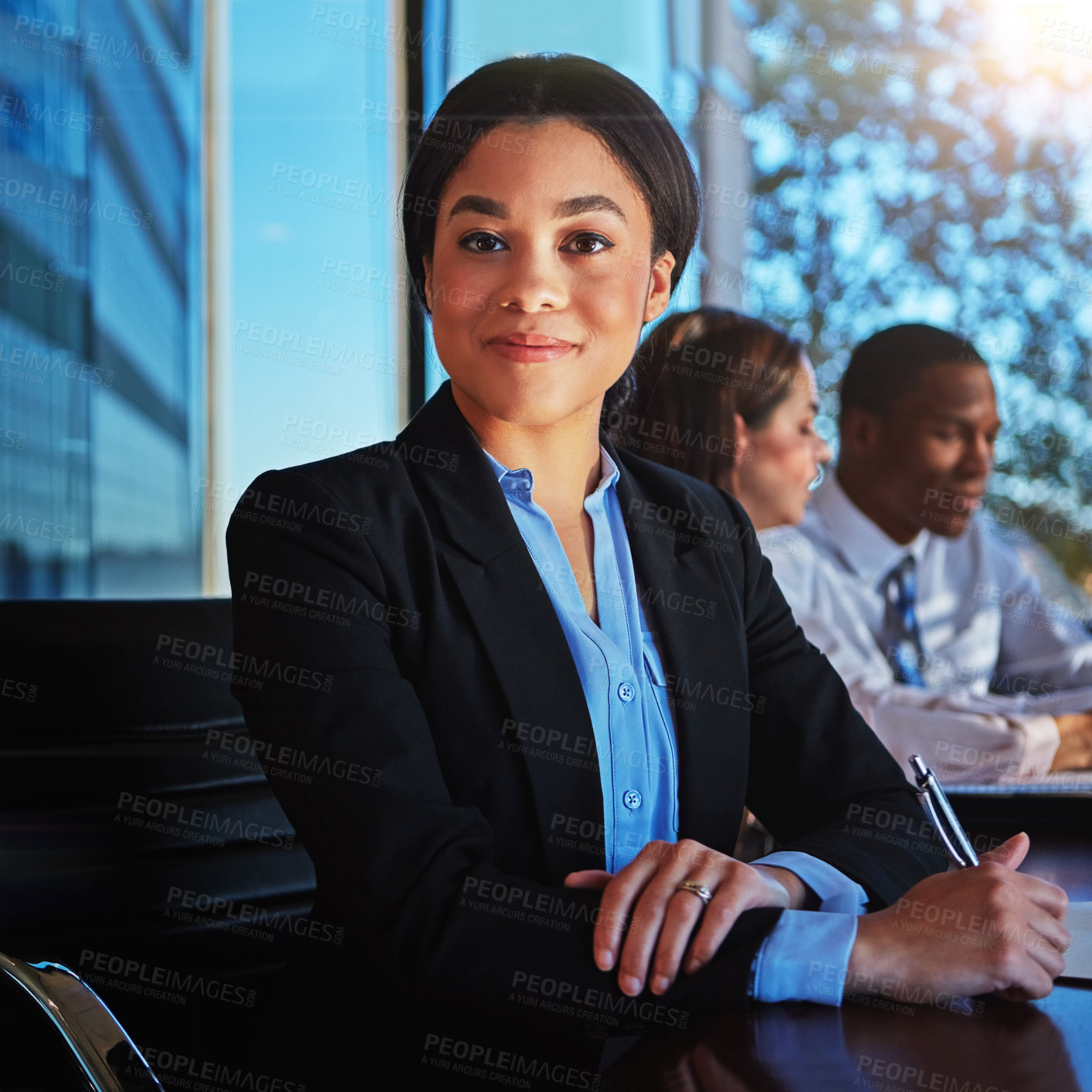 Buy stock photo Cropped portrait of a young businesswoman sitting in a meeting with her boardroom