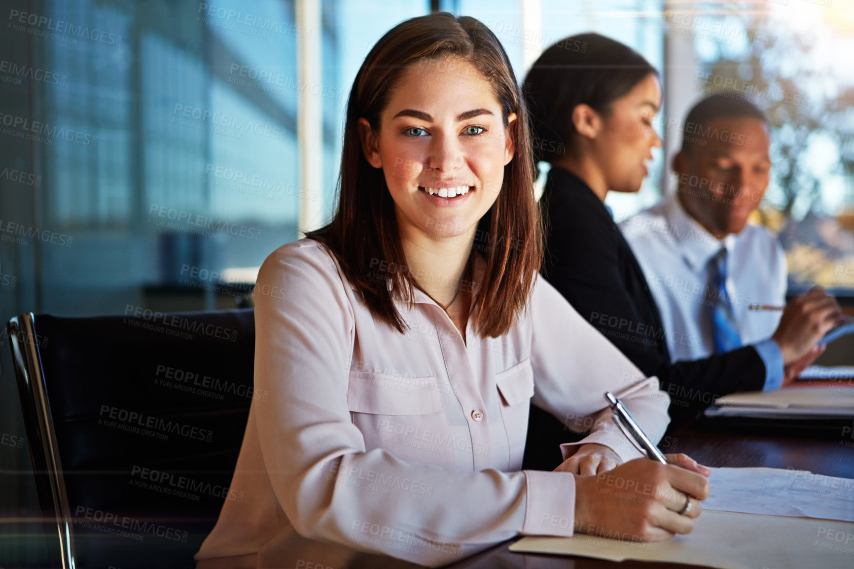 Buy stock photo Cropped portrait of a young businesswoman sitting in a meeting with her boardroom