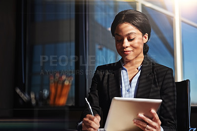 Buy stock photo Shot of a young woman contemplating while using her digital tablet