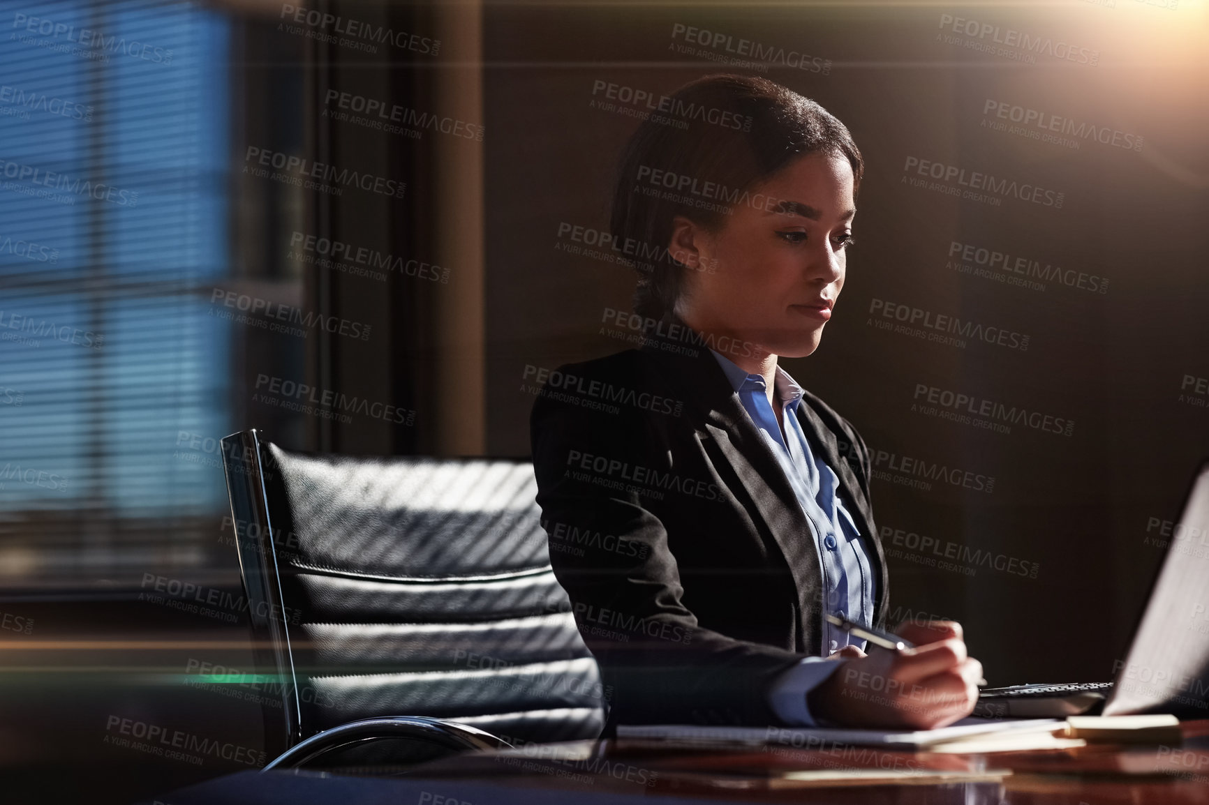 Buy stock photo Shot of a businesswoman using her laptop at her desk