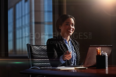 Buy stock photo Shot of a young woman contemplating while using her laptop