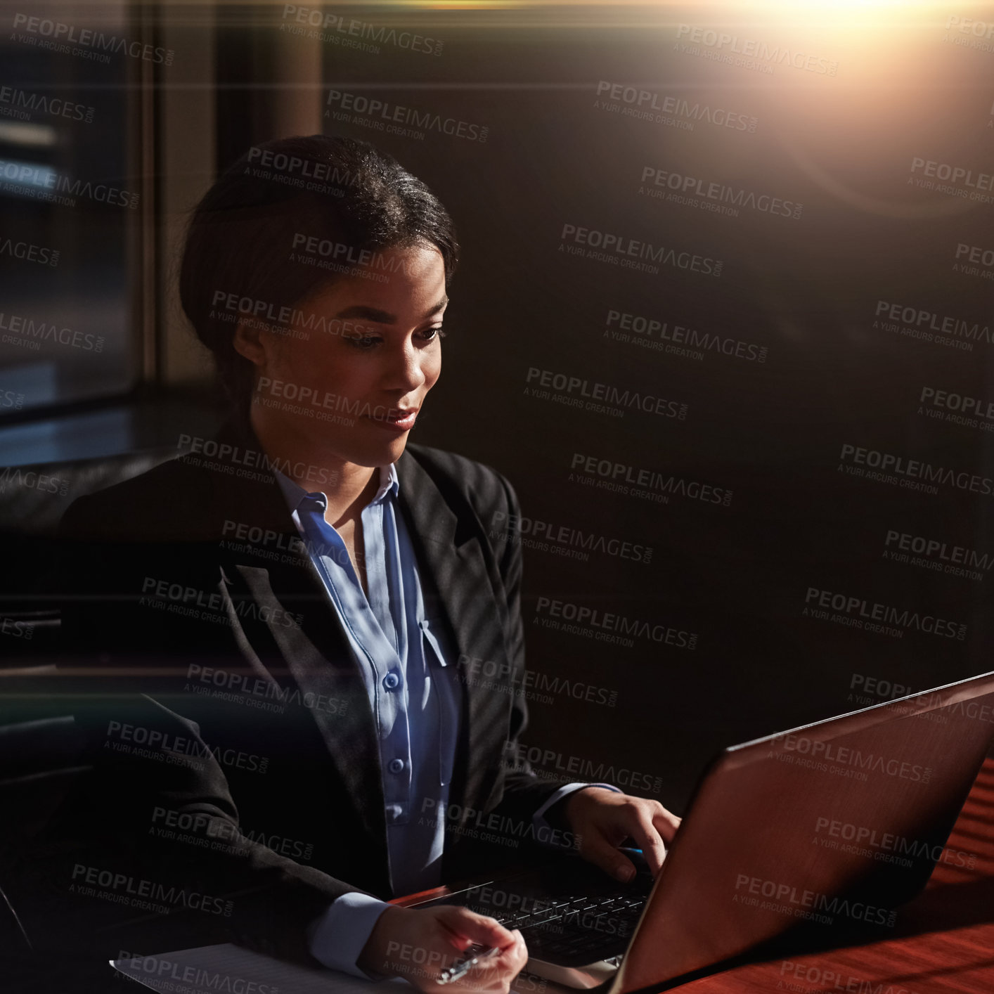 Buy stock photo Shot of a businesswoman using her laptop at her desk