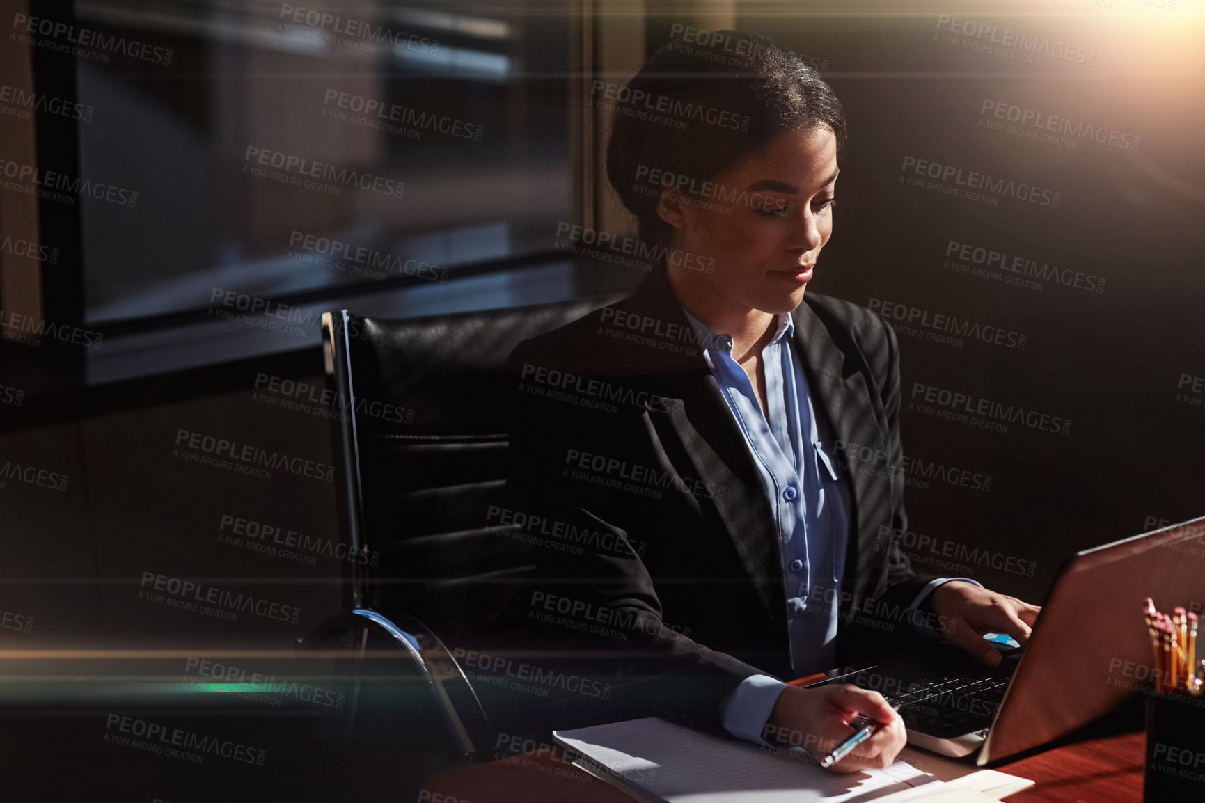 Buy stock photo Shot of a businesswoman using her laptop at her desk