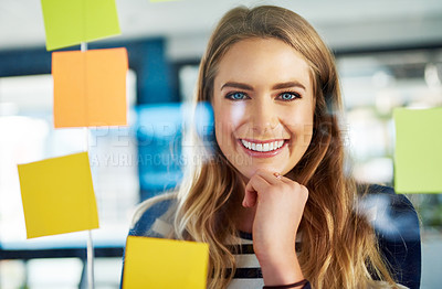 Buy stock photo Portrait of a young woman having a brainstorming session with sticky notes at work