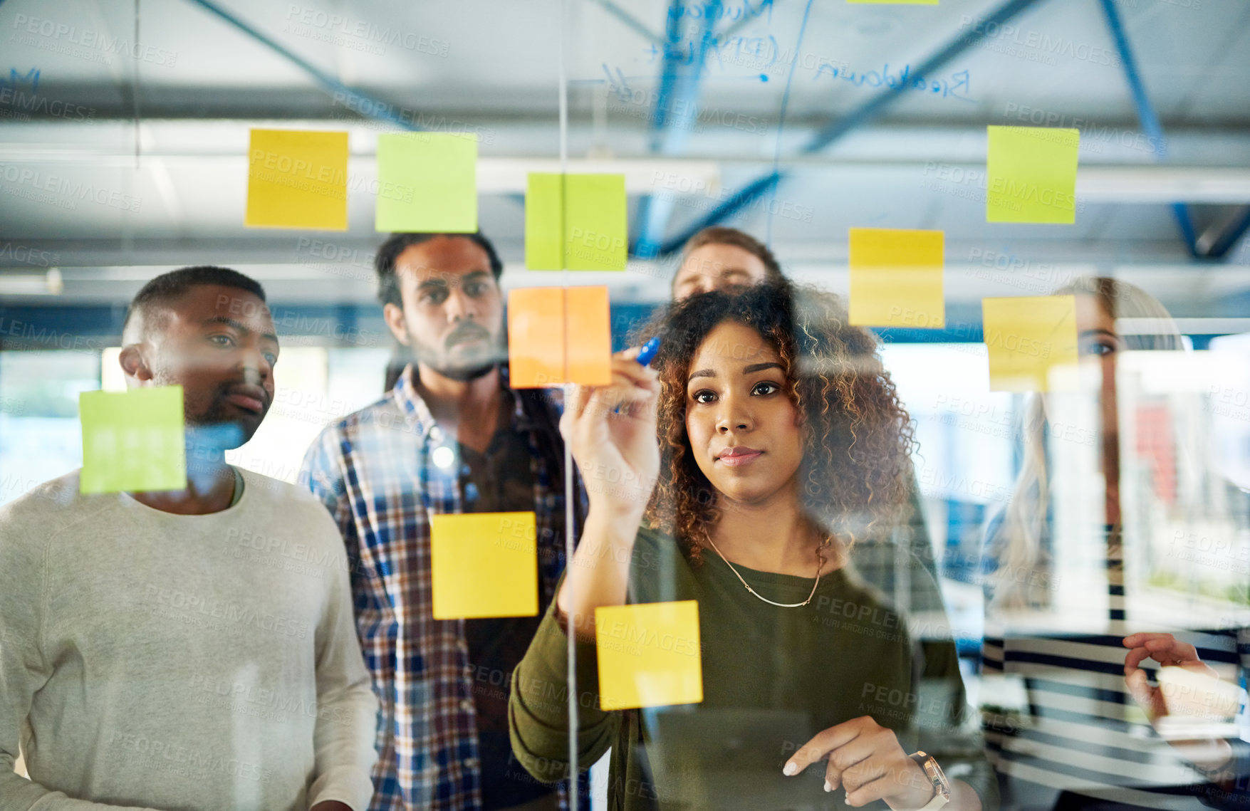 Buy stock photo Shot of colleagues having a brainstorming session with sticky notes at work