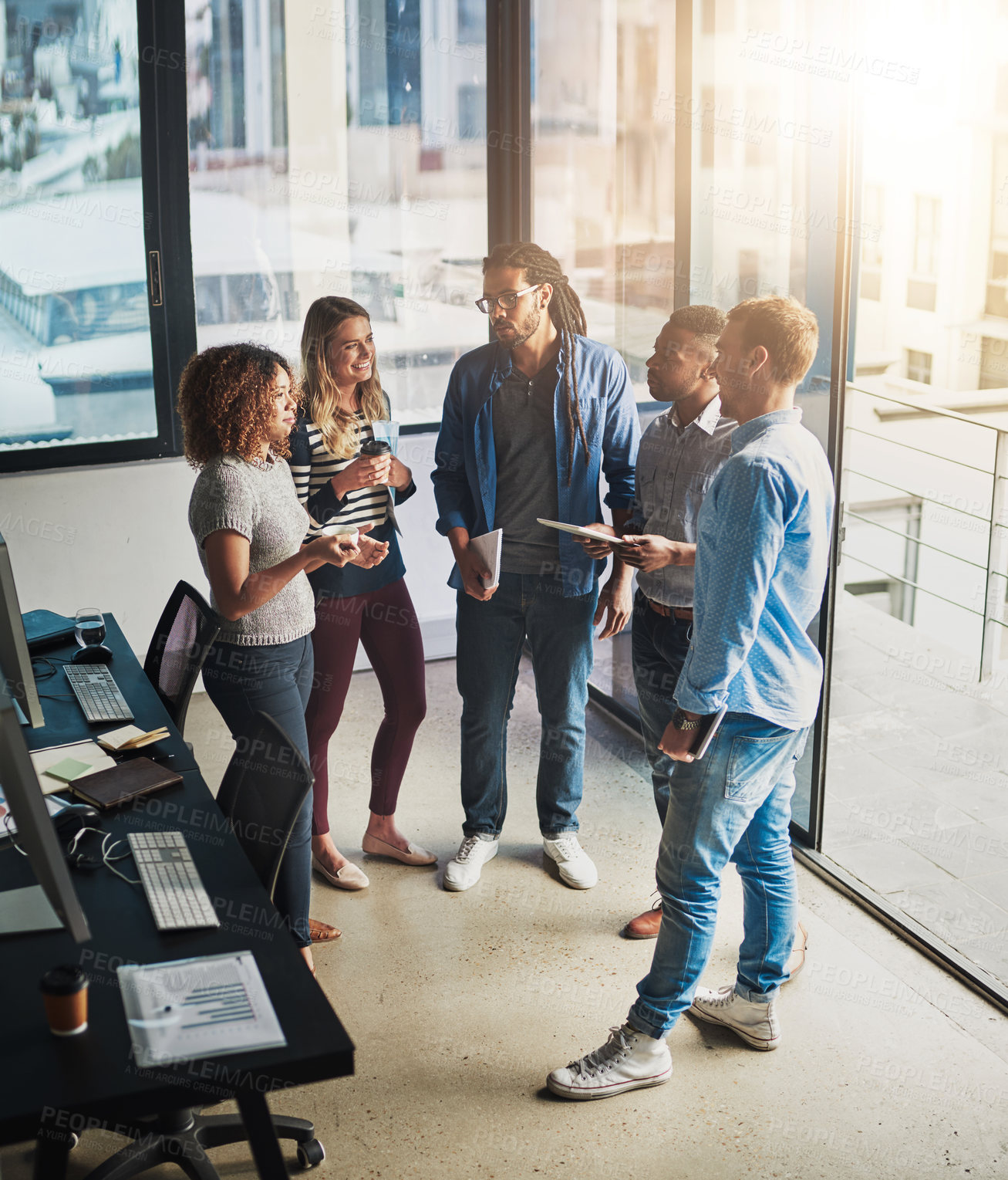 Buy stock photo High angle shot of a group of young designers talking in their office