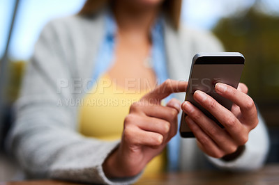 Buy stock photo Closeup shot of an unrecognizable woman texting on her cellphone
