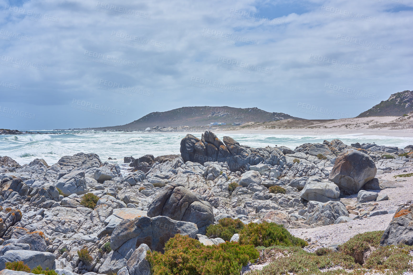 Buy stock photo Beach, outdoor and tropical scenery with rocks, sea and sand at holiday and trip location. Coast, nature and ocean with waves, boulder and paradise with water and landscape in Chile with clouds