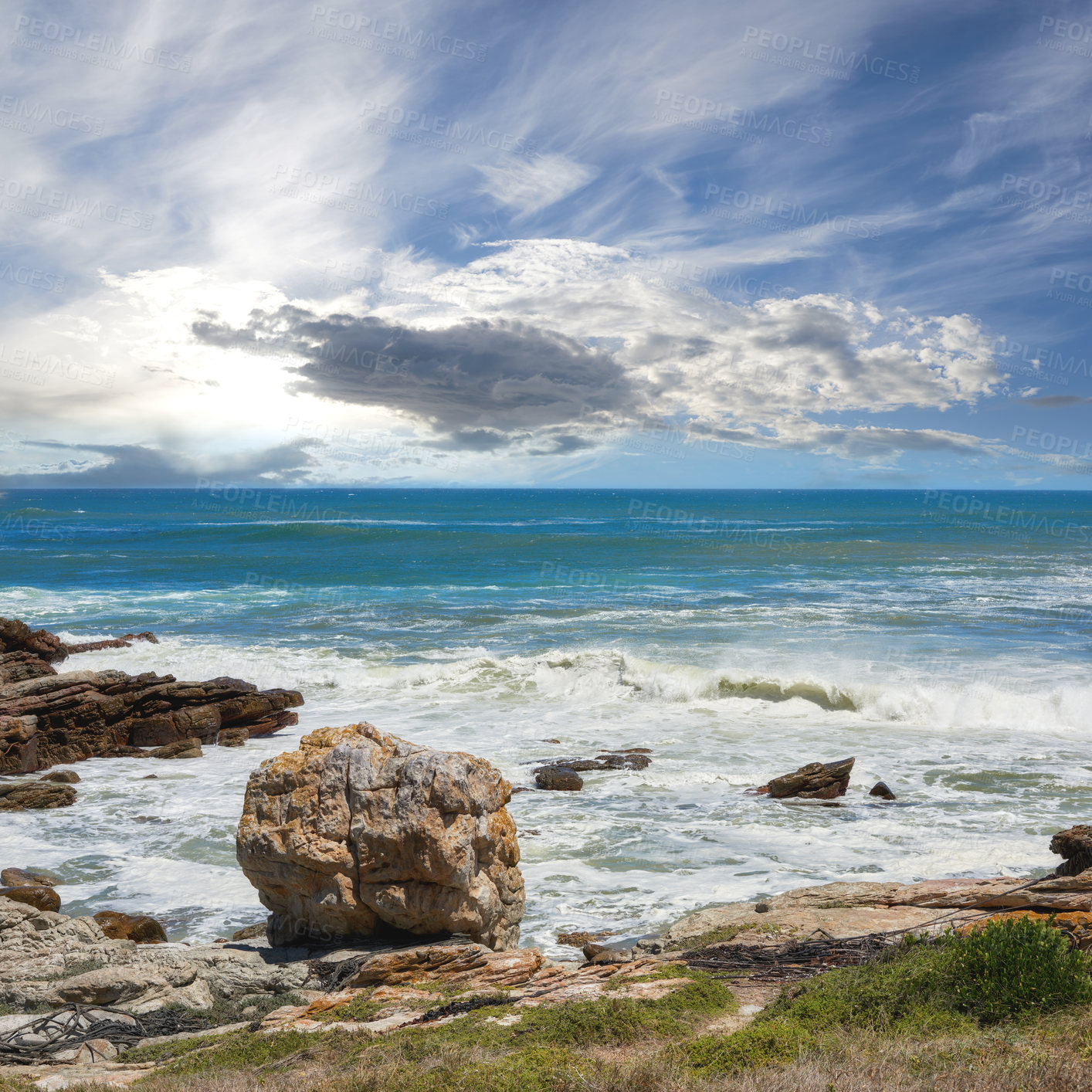 Buy stock photo Rocks, beach and sea coast for travel, holiday or vacation in nature with clouds outdoor. Ocean water, stones or waves in horizon with grass for tourism, adventure island or environment in California