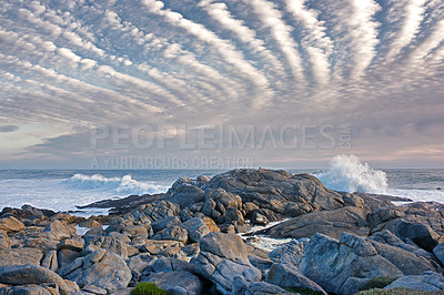 Buy stock photo Stones, beach horizon and ocean for travel, holiday or vacation in nature with clouds outdoor. Sea water, rocks and waves on coast with land for tourism, adventure island and environment in Ireland