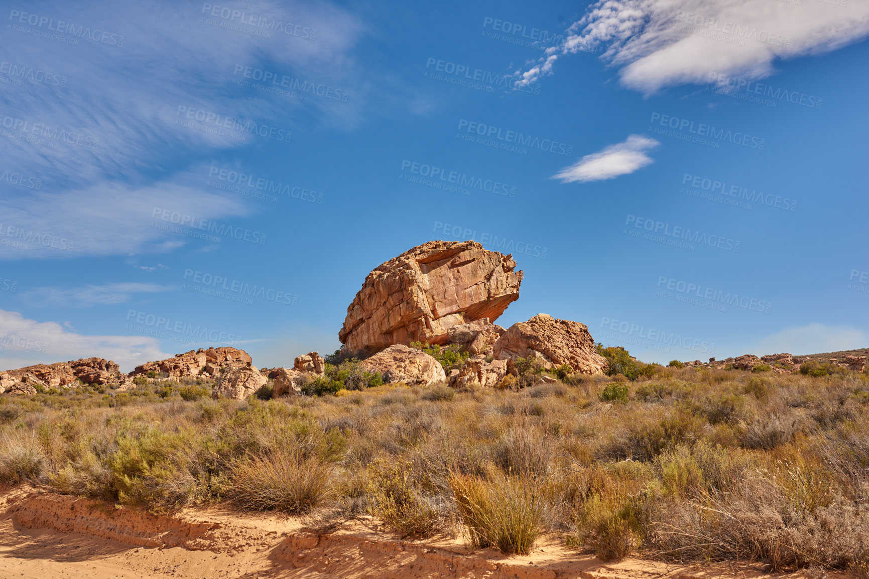 Buy stock photo Field, boulder and sky with rock, formation and geology at location, bush and clouds in summer. Countryside, stone and landscape at nature park, outcrop and erosion with sunshine in South Africa