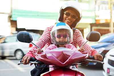 Buy stock photo Portrait of a mother and her little daughter sitting on a scooter outside