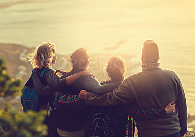 Buy stock photo Shot of a group of friends on a mountain top
