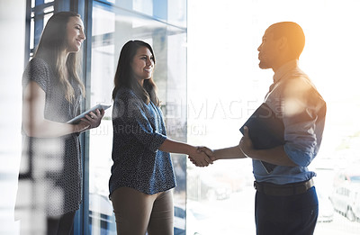 Buy stock photo Handshake greeting between business women, entrepreneur and accountant banker with tablet and portfolio. Happy female and male corporate professionals meeting, welcoming or making deal on investment