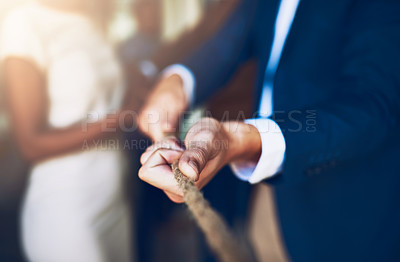 Buy stock photo Cropped shot of corporate businesspeople pulling on a rope during tug of war