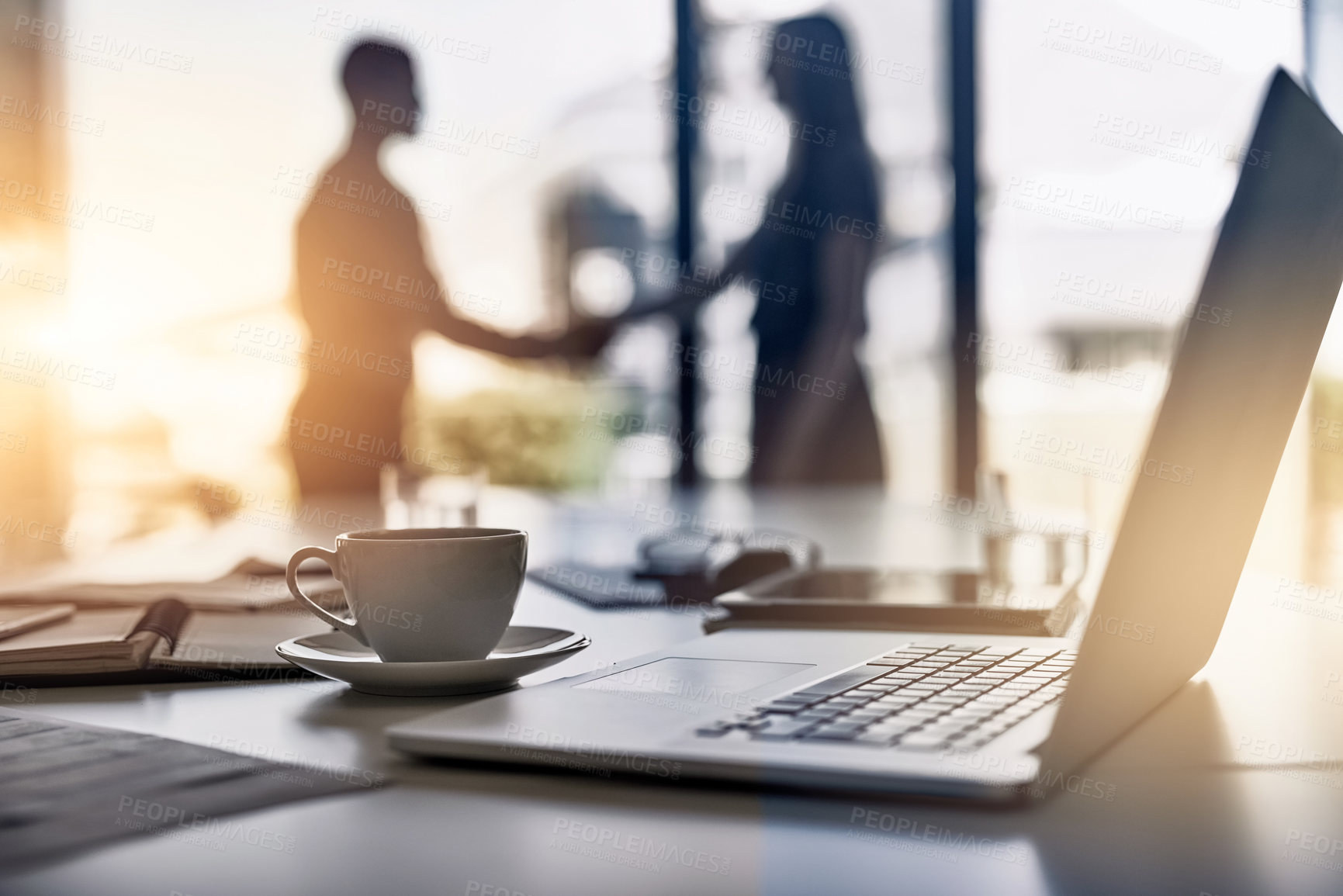 Buy stock photo Handshake, laptop and business people silhouette with lens flare, crm and thank you with greeting and welcome of staff. Tech, cup and desk at a company in the morning at meeting with computer and b2b