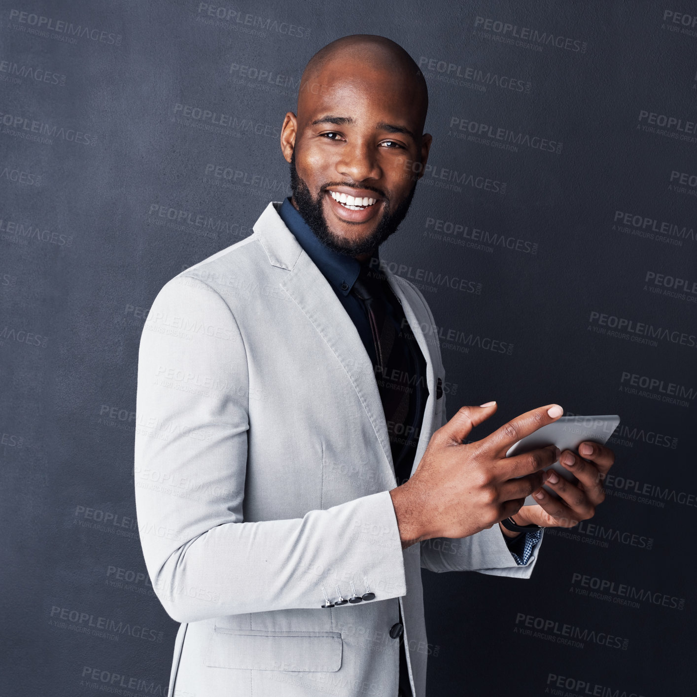 Buy stock photo Studio shot of a businessman using a digital tablet against a gray background