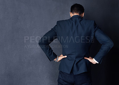 Buy stock photo Rearview studio shot of a businessman standing against a gray background