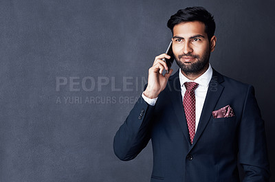 Buy stock photo Studio shot of a young businessman using a mobile phone against a gray background