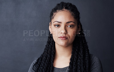 Buy stock photo Studio shot of a young woman posing against a gray background