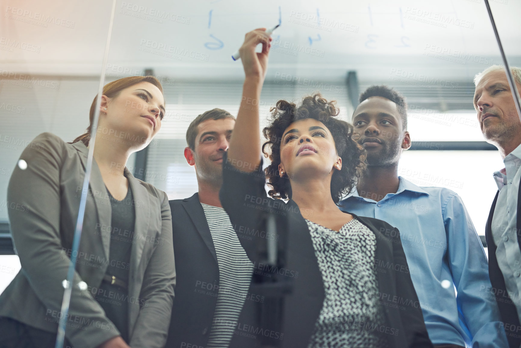 Buy stock photo Woman, writing and glass with business people in teamwork for strategy, planning and collaboration in office. Female leader, pen and brainstorming with group, ideas and notes for goal with diversity