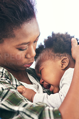 Buy stock photo Cropped shot of a young mother cradling her baby boy