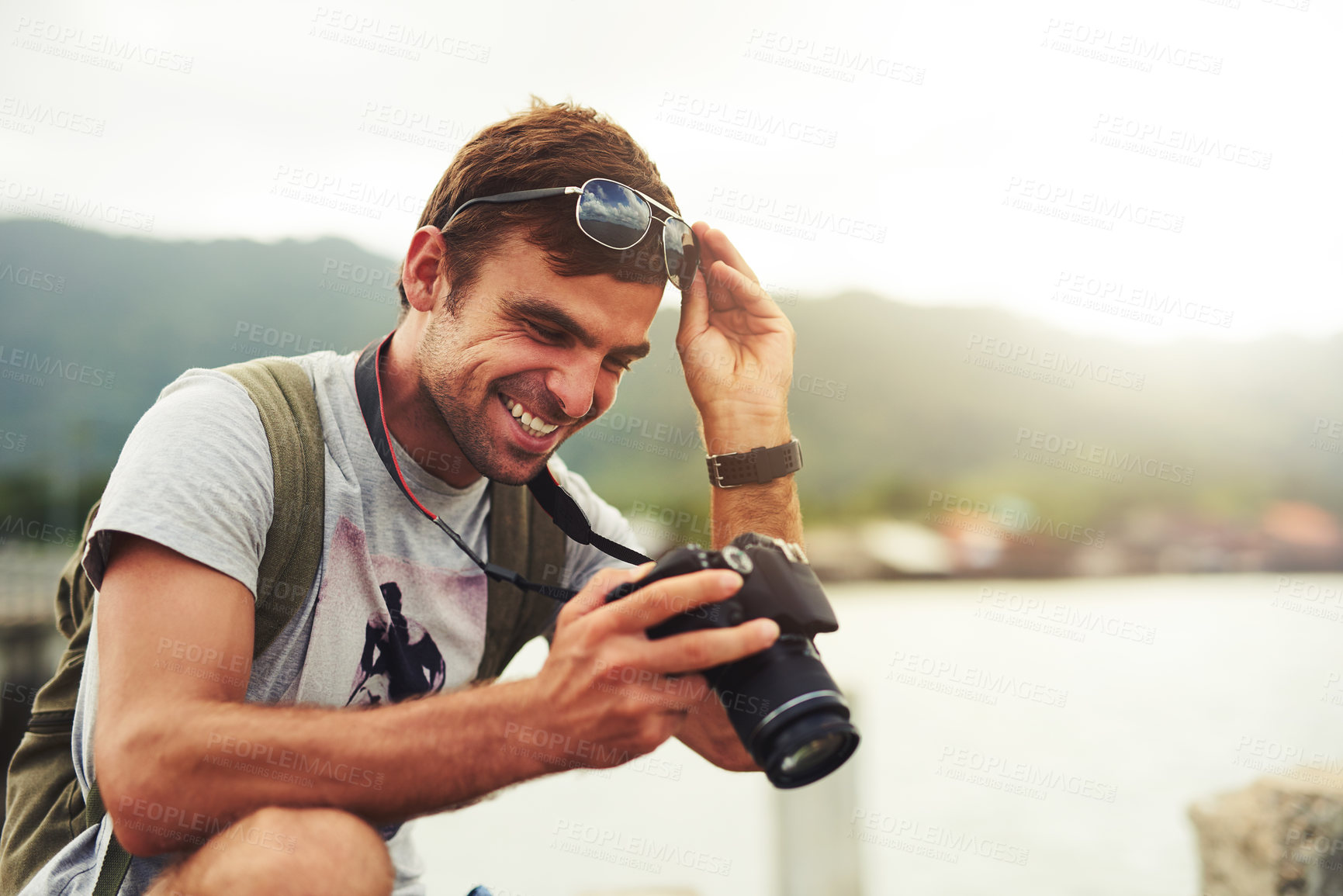 Buy stock photo Man, camera and travel photographer at ocean as photo journalist for tourism, hobby or water. Male person, pictures and outdoor creative at sea in Australia or blog equipment, view or professional