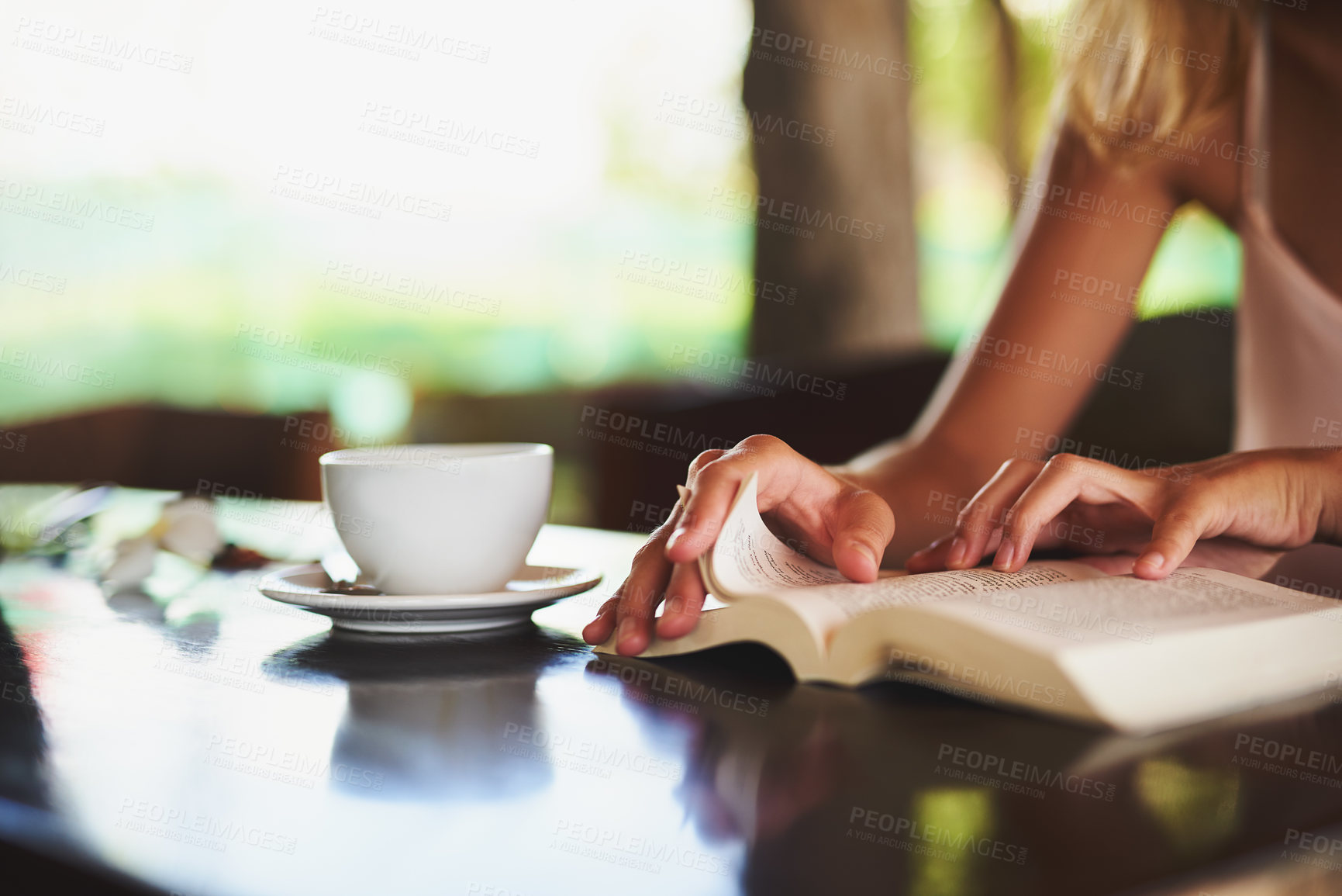 Buy stock photo Hands, person and reading book in cafe for story, knowledge and student learning literature information in university. Closeup, education and studying novel on coffee shop table at college to relax