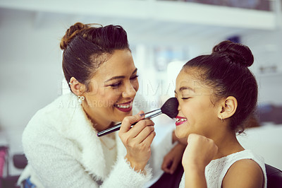 Buy stock photo Backstage, makeup or nose with girl and stylist in studio, getting ready behind the scenes. Child model, cosmetics and blusher brush with playful woman on set for creative preparation of talent