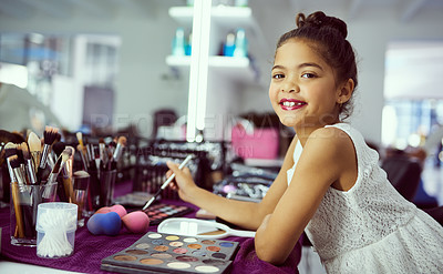 Buy stock photo Portrait of a cute little girl playing with makeup in a dressing room