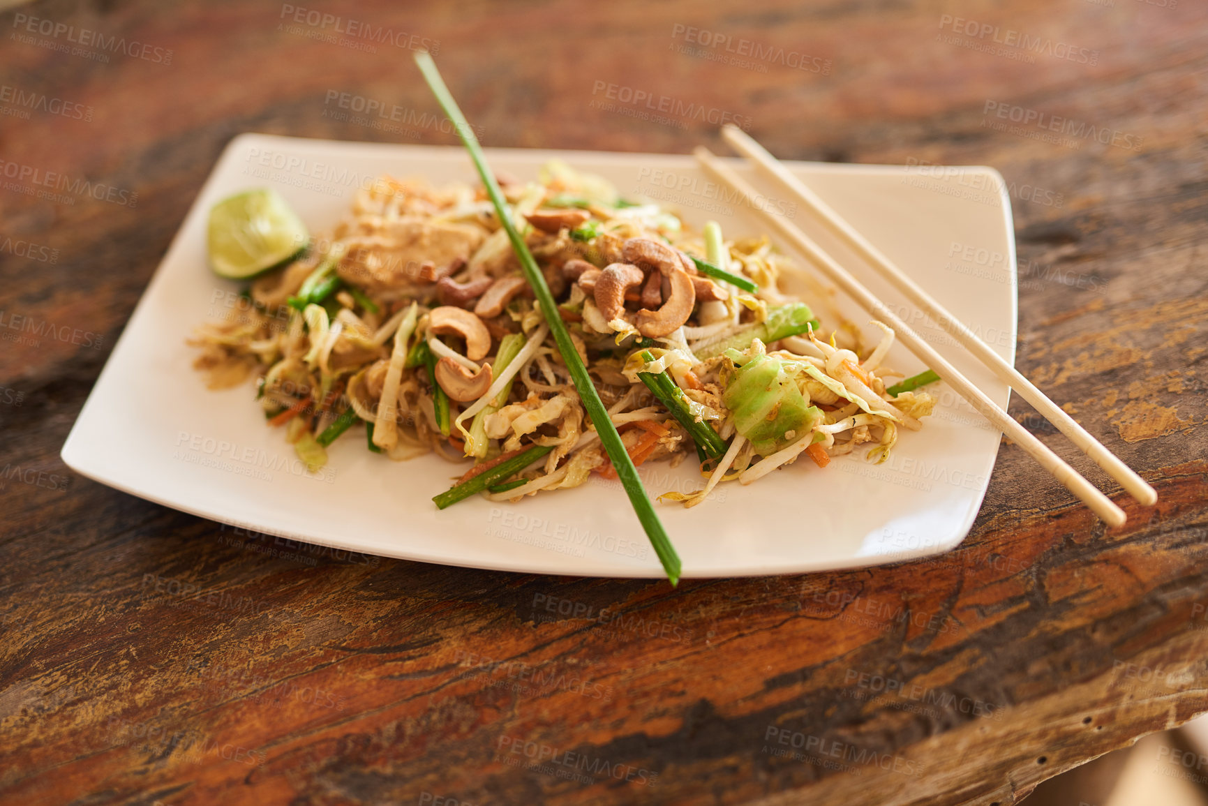 Buy stock photo Closeup shot of Chinese food on a plate on a wooden table
