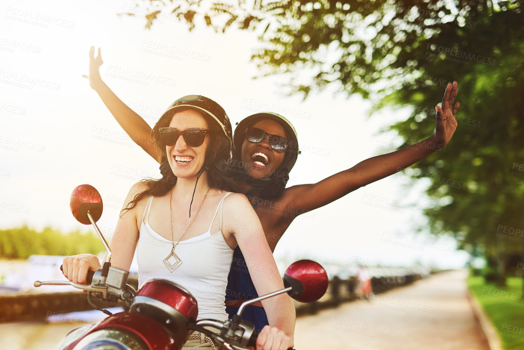 Buy stock photo Shot of two friends enjoying a ride on a scooter together
