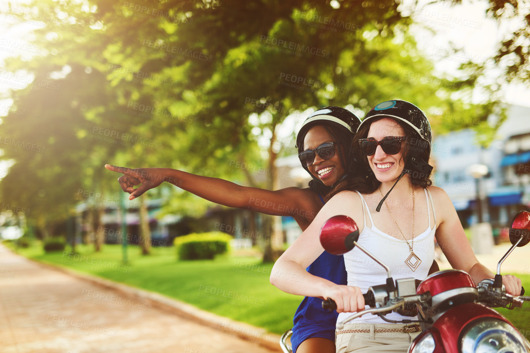 Buy stock photo Travel, scooter and happy women with helmet pointing for adventure, summer vacation or sightseeing. Outdoor, holiday and friends with sunglasses for transportation, explore or road trip to India