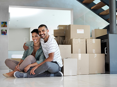 Buy stock photo Portrait of a happy young couple sitting on their living room floor on moving day