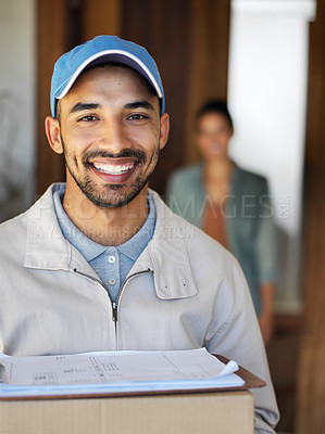 Buy stock photo Portrait of a smiling young courier carrying a package with a customer standing at her front door in the background