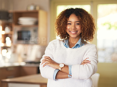 Buy stock photo Portrait of a proud and confident young woman standing in the kitchen of her home