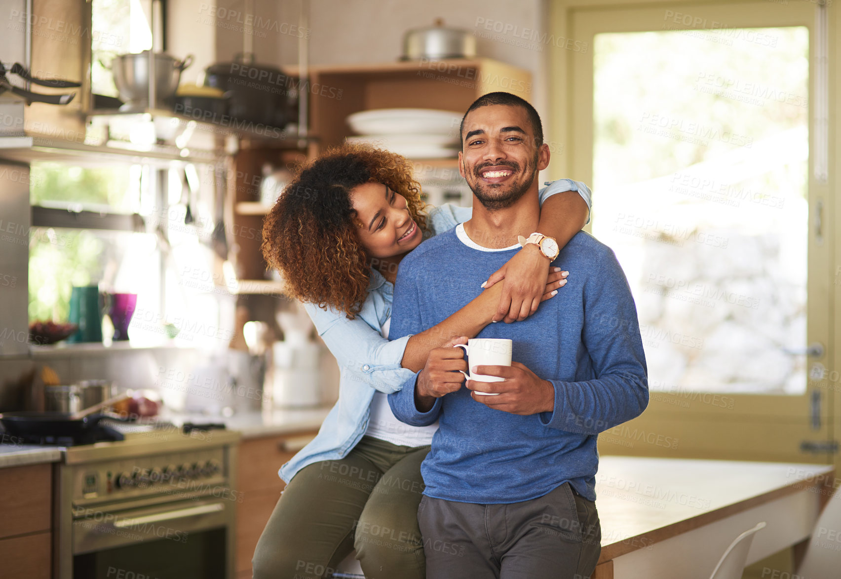 Buy stock photo Black couple relaxing, drinking coffee and looking happy together in the kitchen in the morning at home. Portrait of a young, cheerful and loving husband and wife enjoying romantic time on weekend 