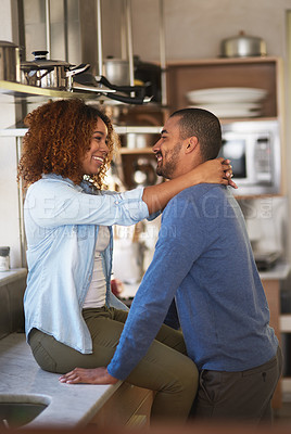 Buy stock photo Shot of a young couple sharing a romantic moment in the kitchen