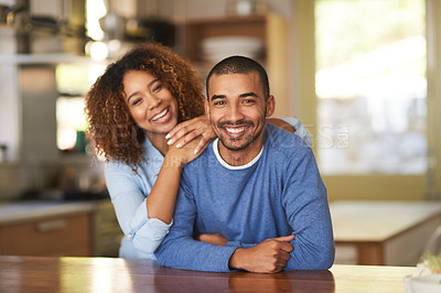 Buy stock photo Portrait of a happy young couple in their kitchen at home