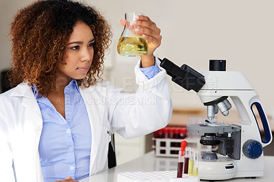 Buy stock photo Cropped shot of a young female scientist conducting an experiment in the lab