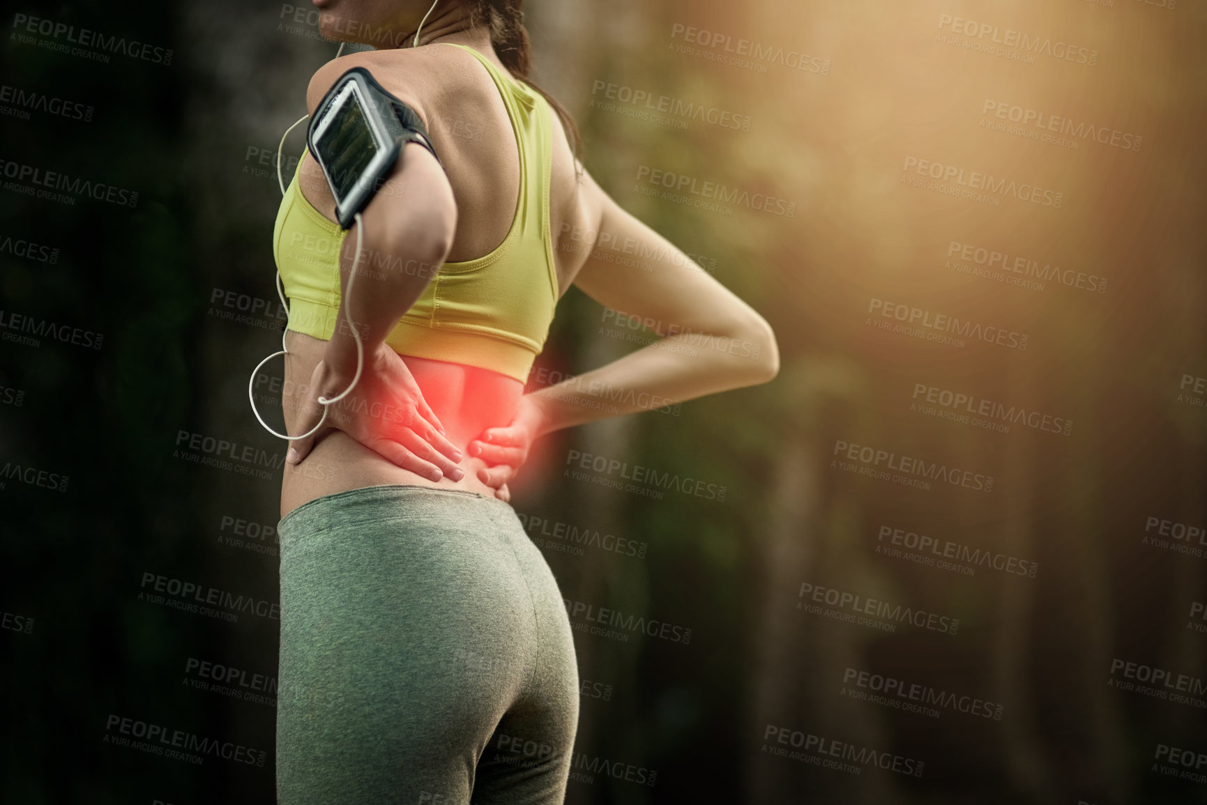 Buy stock photo Cropped shot of a young woman experiencing lower back pain